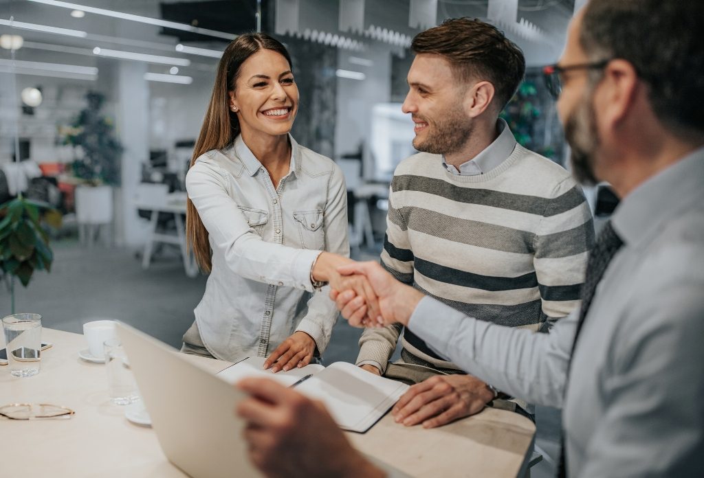 Handshaking while settling a deal with real estate agents